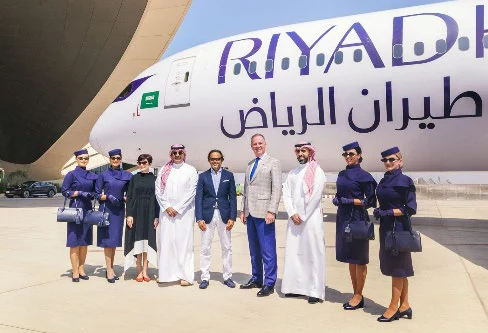 Riyadh Air crew and executives in front of a Riyadh Air aircraft