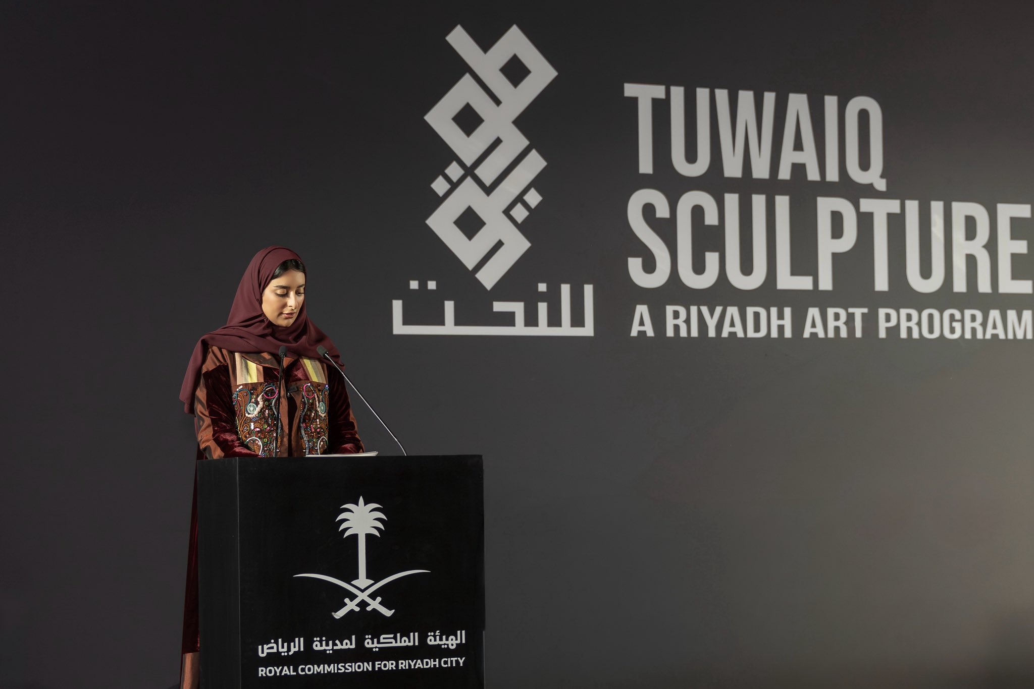 Sarah Alruwayti, Director of Tuwaiq Sculpture, speaking at the preview night