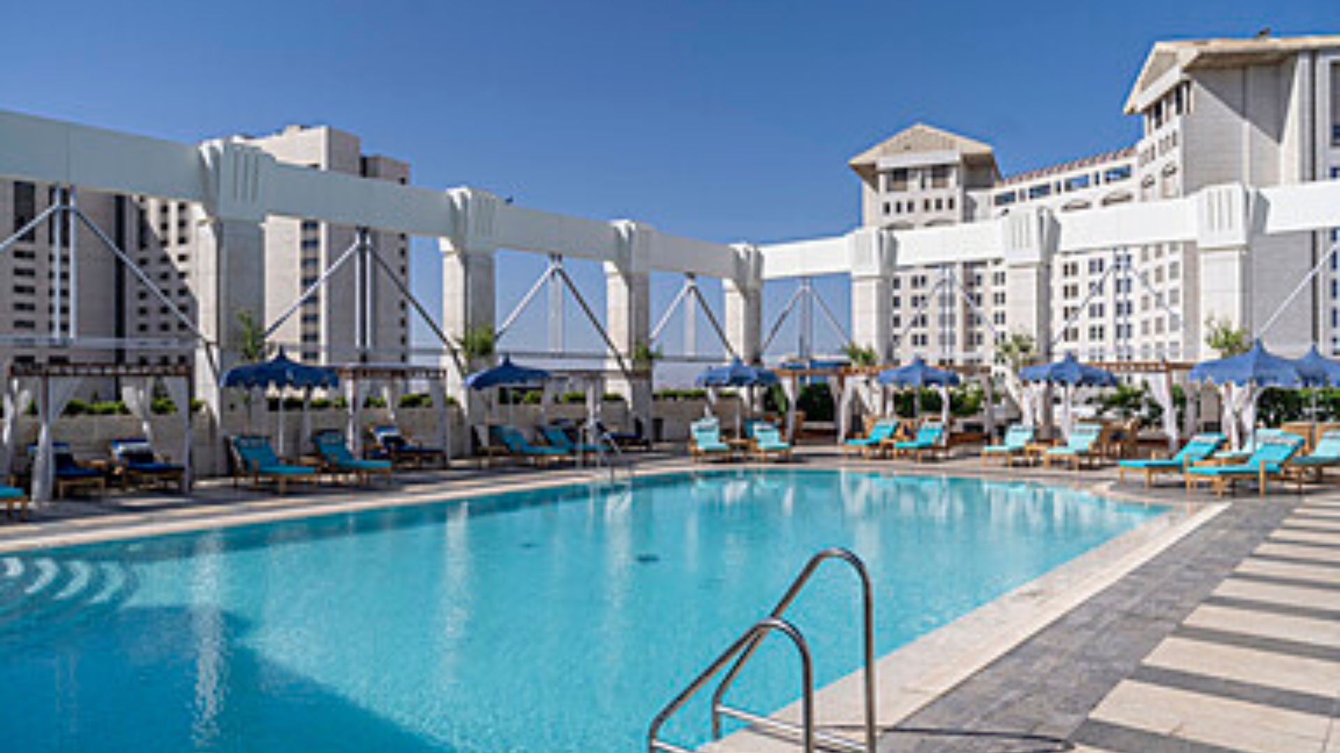 The Exterior Of Four Seasons Hotel Amman Rises Above The City, Offering A Luxury Stay In The Heart Of The Capital