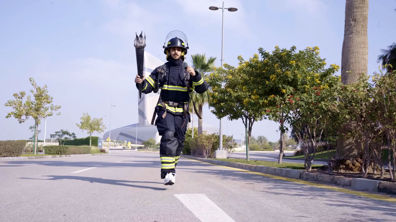 Saudi firefighter prepares for the 16th World Firefighter Games by running in Dharan heat in full uniform and gear.